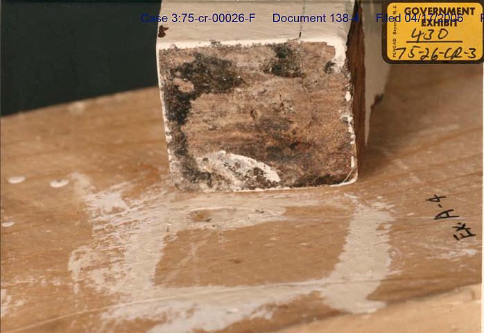 Exhibit A4: Comparison of paint stains<br><br><em>Webmaster note:</em> The piece of wood being compared to Exhibit A4 is a leg of the headboard from the bed in the south bedroom (Kimberly).